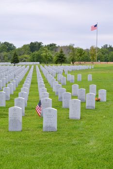 ELWOOD, ILLINOIS/USA - JULY 16: A small American flag honors the gravesite of a World War II veterans and Vietnam veterans at Abraham Lincoln National Cemetery on July 16, 2017 in Elwood, Illinois.