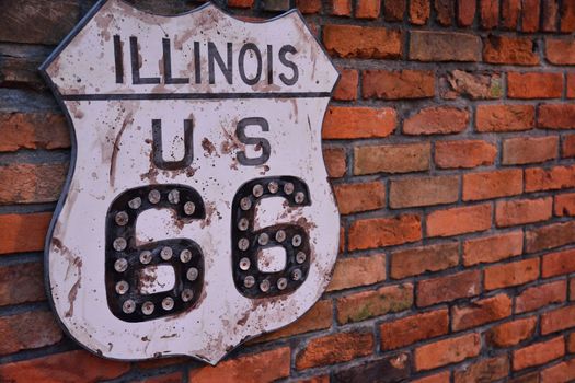 Historic Route 66 road sign painted on a brick wall in Illinois