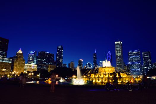 Chicago skyline panorama with skyscrapers and Buckingham fountain at night.