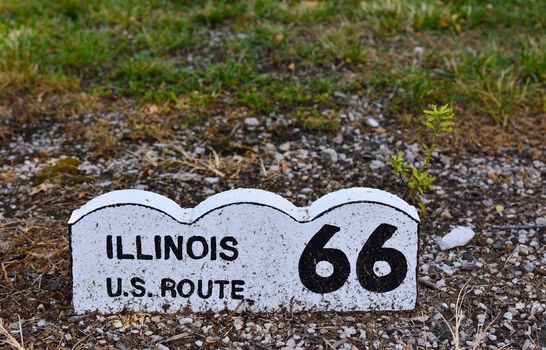 Historic Route 66 road sign on a brick in Illinois.