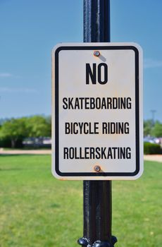 Sign prohibiting bicycles, rollerskating and skateboards.