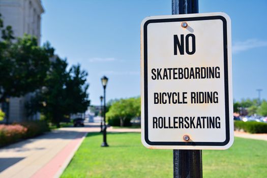 Sign prohibiting bicycles, rollerskating and skateboards.