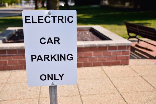 Black and white sign with reserved parking electric vehicles. Only text