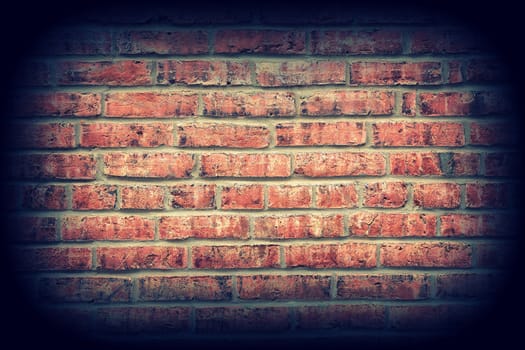 Red brick wall texture background with vignetting corners