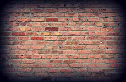 Red brick wall texture background with vignetting corners