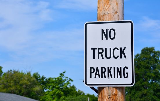 No truck parking sign in city.