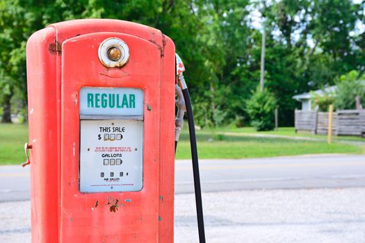 Old rusty american gas pump, displaying the price in dollars and filling amount in gallons.