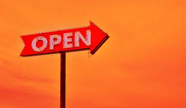 Open neon old sign in route 66 at sunset