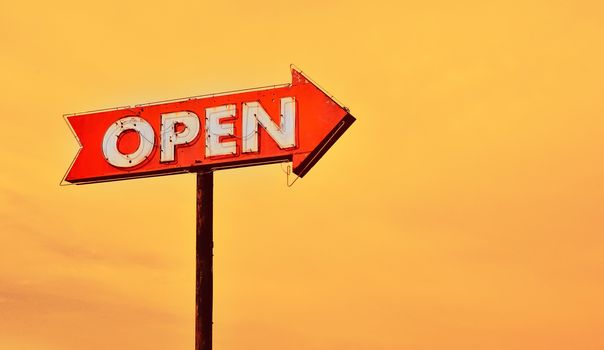 Open neon old sign in route 66 at sunset