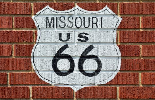 Historic Route 66 road sign painted on a brick wall in Missouri