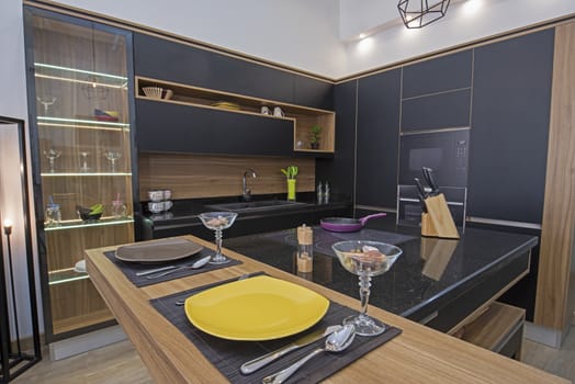 Interior design decor showing modern kitchen with cupboards and island in luxury apartment showroom