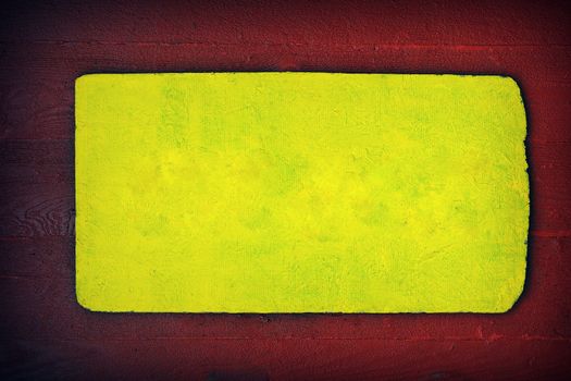 A rustic wooden sign in red and yellow, color copy space.
