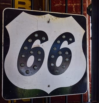 Historic old Route 66 black sign.