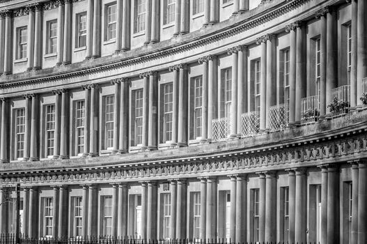 close up of a row of large ornate townhouses on a street in the Circus, the famous historic district in Bath, England, in Somerset
