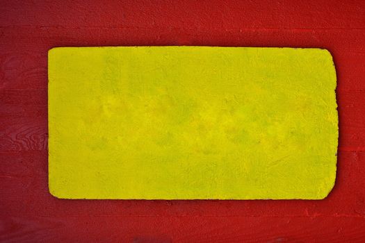 A rustic wooden sign in red and yellow, color copy space.