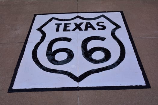 Historic Route 66 sign on the asphalt in Texas.