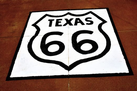 Historic Route 66 sign on the asphalt in Texas.