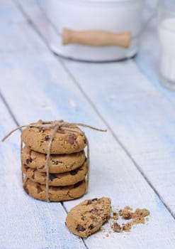 Stacks of homemade chocolate chip cookies on wooden table