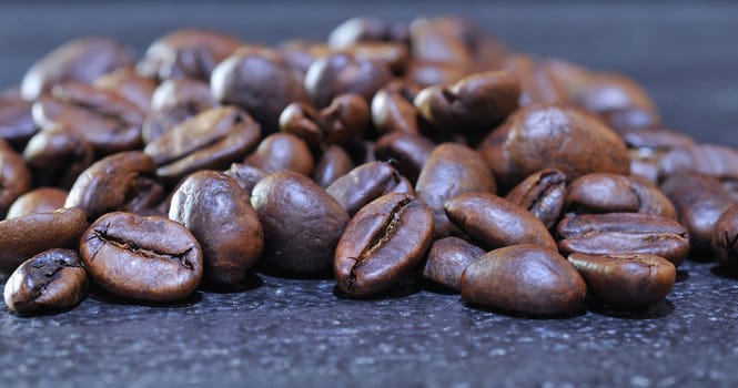 Roasted coffee beans on black background