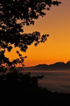 Idyllic scene on mountain silhouette at sunset