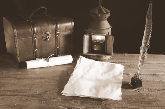 Work desk with parchment, inkwell and pen.