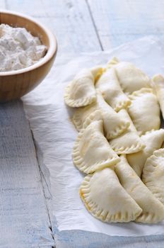 Raw dumplings on baking paper