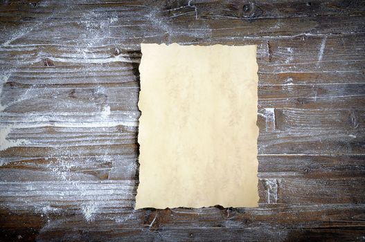 Parchment on wooden table, from above.