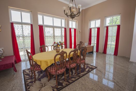 Dining area in luxury villa show home showing interior design decor furnishing with wooden table and chairs