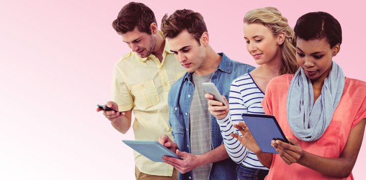 Smiling creative team standing in a line using technology against pink background