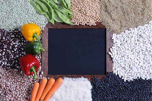 Different kind of cereals with red,green,yellow peppers, carrots and green peas. From above