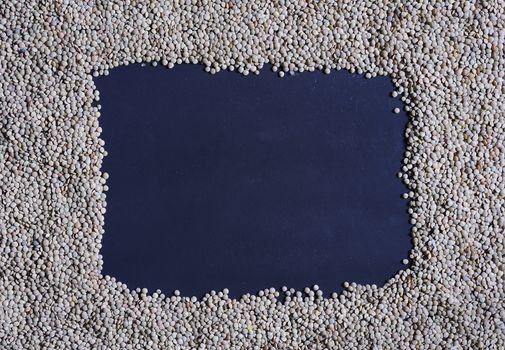 Blue frame on table made of lentils. From above