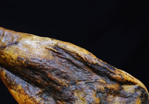 Iberian ham on black background