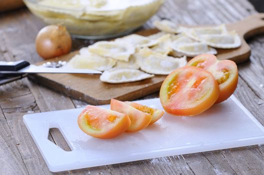 Sliced tomato on white board in close-up