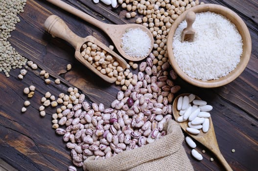 Close-up of different cereals on wooden table. From above