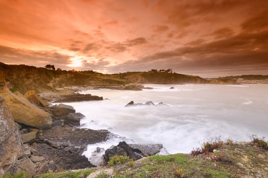Beautiful view on rocky beach under bright sky.Long exposure