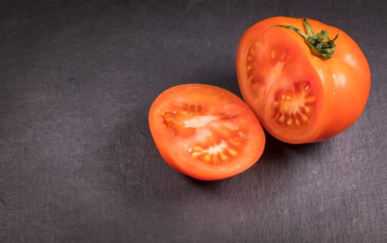Tomato sliced on a slate stone