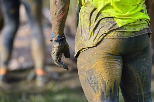 Back view of sportsman in dirty sportswear. Close-up. Unrecognizable
