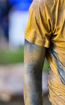 Focused sportsman's hand in dirty sportswear. Close-up. Unrecognizable