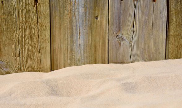Wooden cracked boards. Sand on foreground