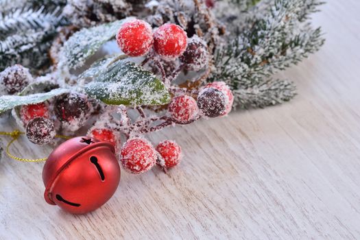 Close-up of Christmas snowed fir tree branch with xmas red ball