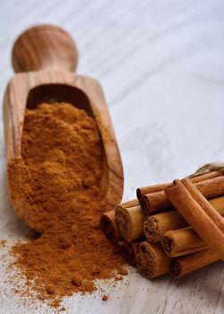 Close-up of powdered cinnamon with sticks on table