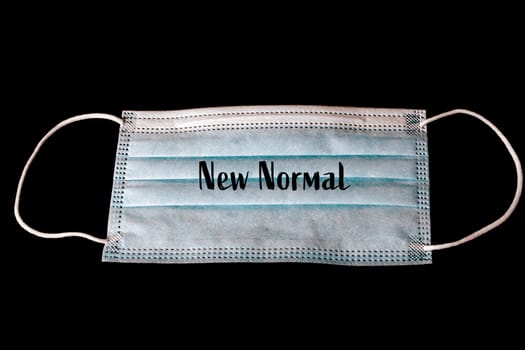 Face protection mask with the words new normal as a concept after the covid-19 pandemic