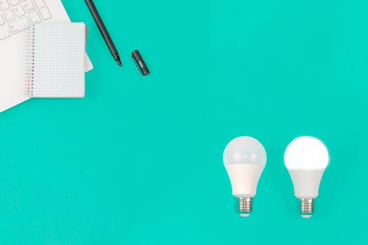 Light Bulb, Laptop and Notepad on Blue Background