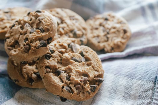 American chocolate cookies on blue cloth prepared for breakfast in the morning sunlight.Ideal for a tasty breakfast