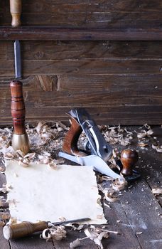 Carpenter tools with blank parchment on the workbench carpentry.