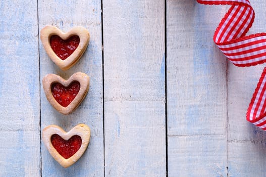 Homemade cookies for valentines day over wooden table