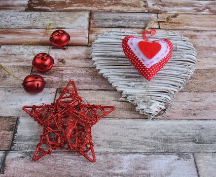 Close-up of Christmas decoration on wooden surface - star, heart and balls.