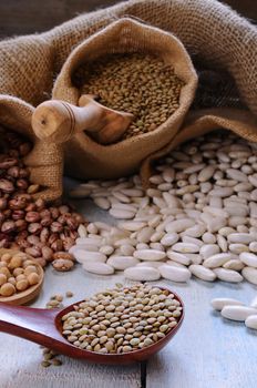 Close-up of various of bean cultures on table in textile brown bag