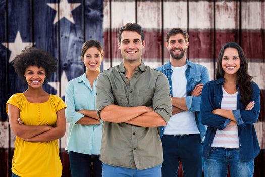 Group portrait of happy young colleagues against composite image of usa national flag