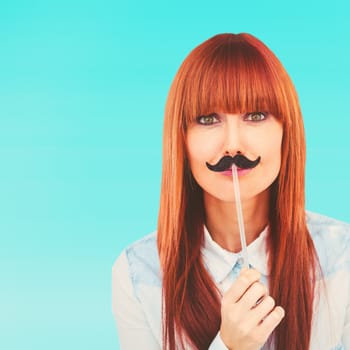 Portrait of a hipster woman with a mustache against bright blue sky